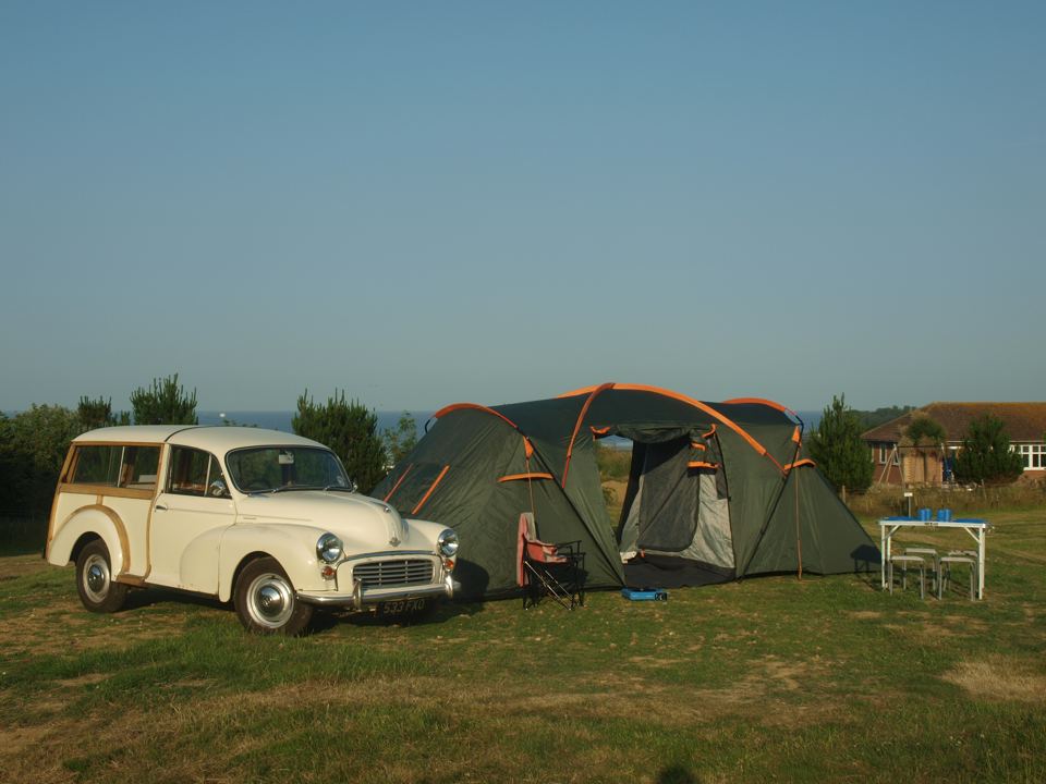 Tent and Morris Minor on the field