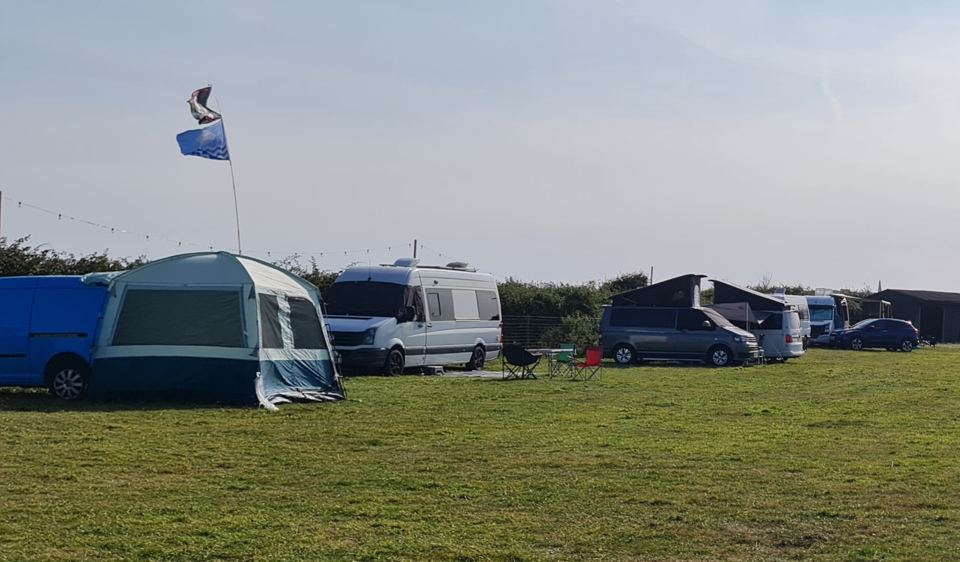 Awnings and campervans on the field