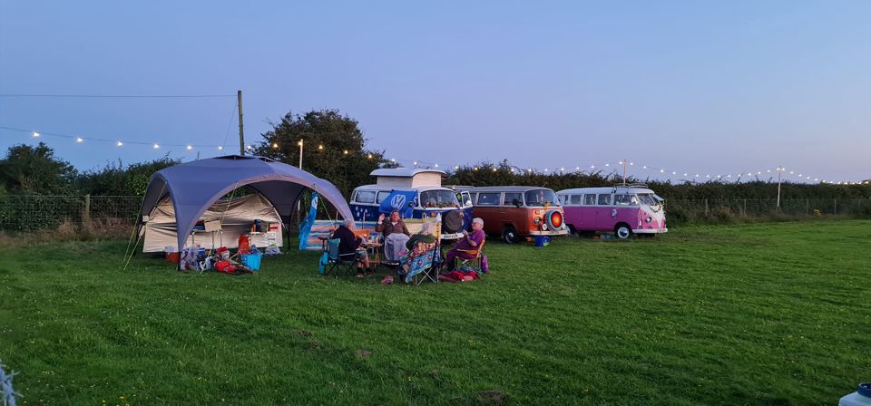 Campervans on the field at dusk