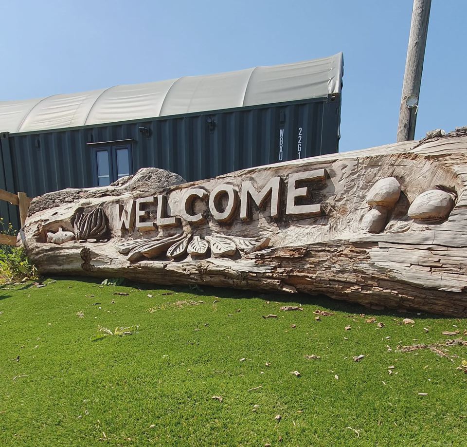 Carved welcome log by a lodge