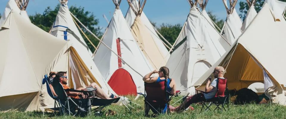 Tipis with campers relaxing