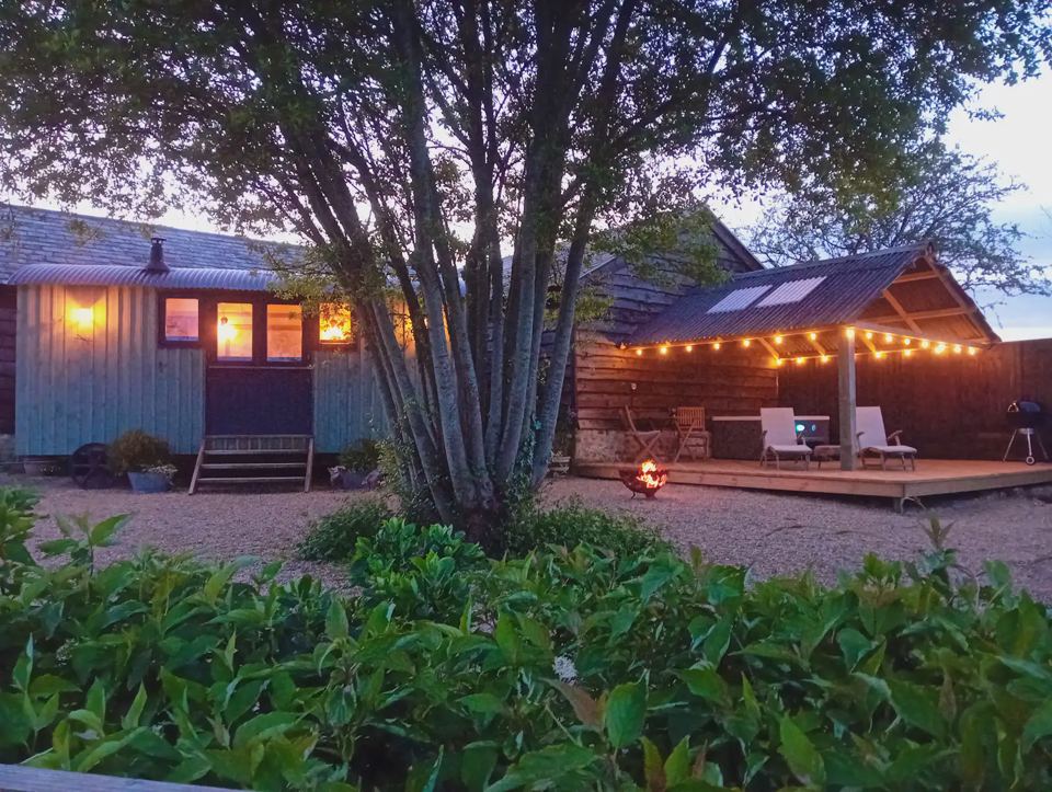 Hut and covered deck at dusk