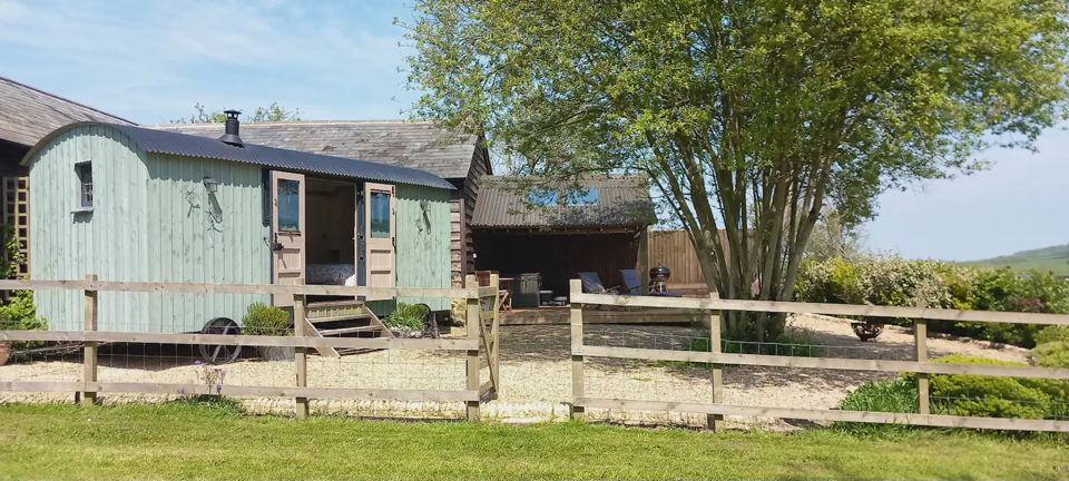 Shepherd's hut in its garden