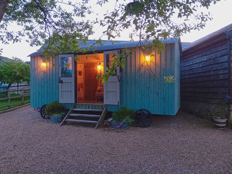 Shepherd's hut lit at dusk