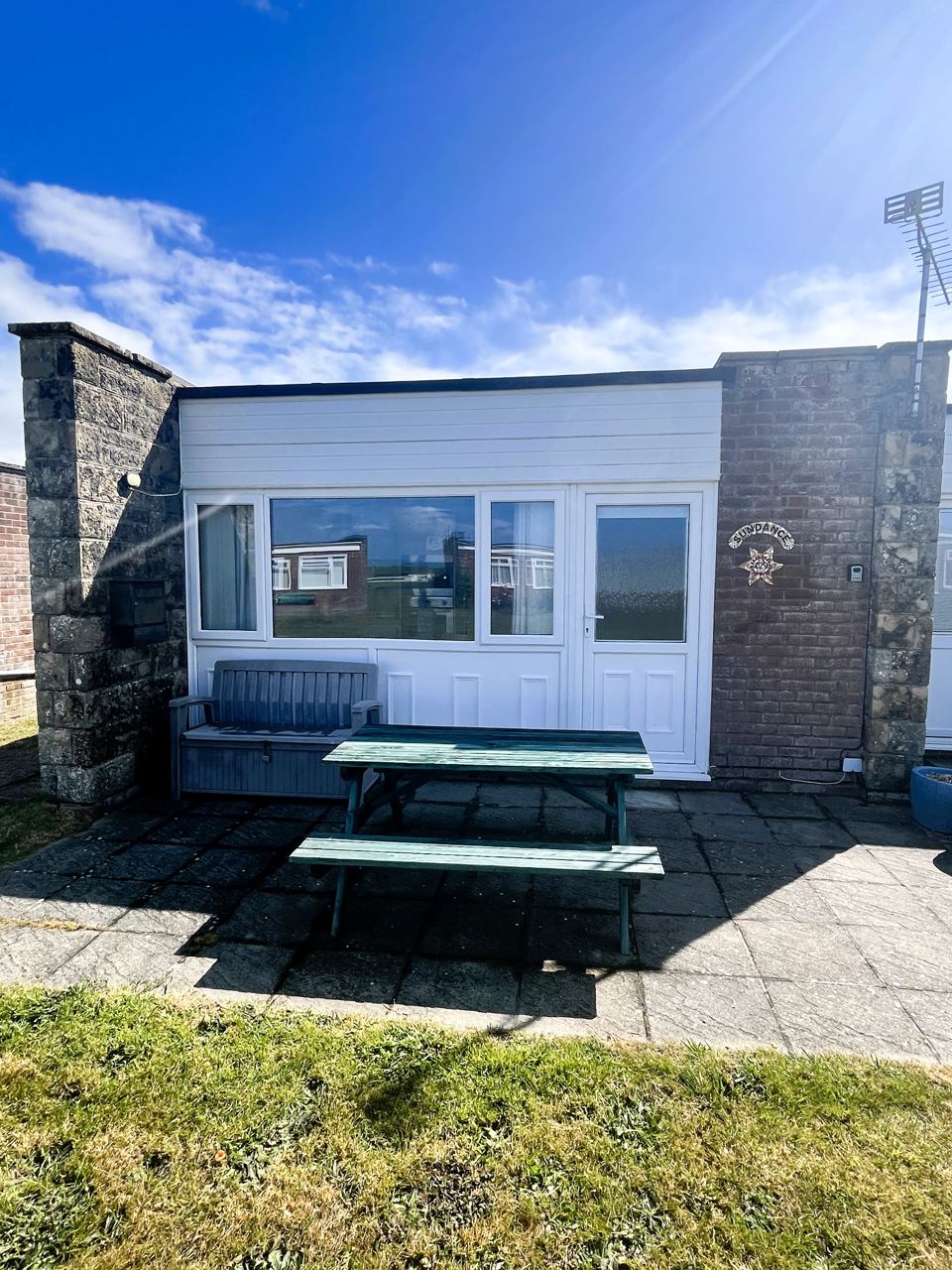 Bungalow with patio and bench