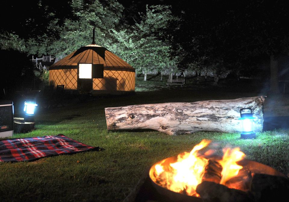 Yurt and fire pit at night
