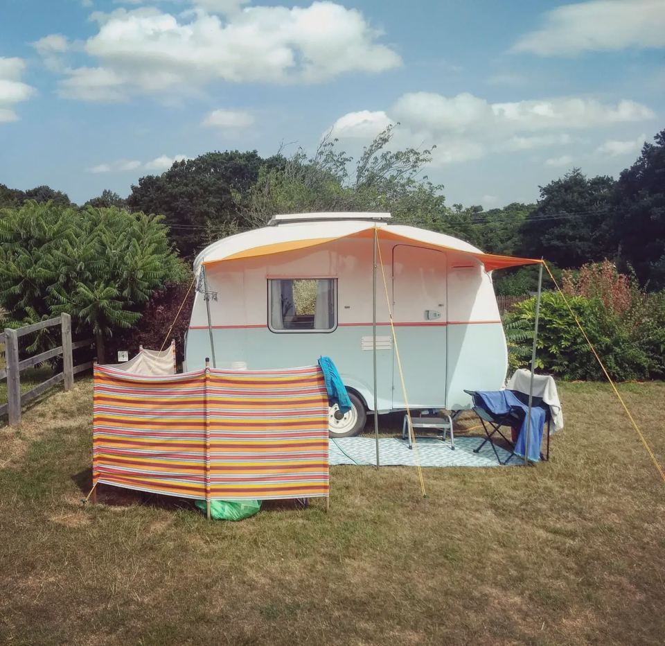 Small caravan with a windbreak