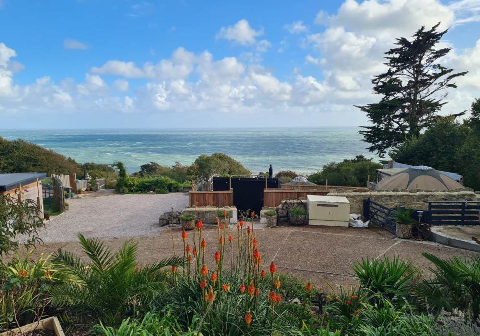Gravel yard and gardens above the sea