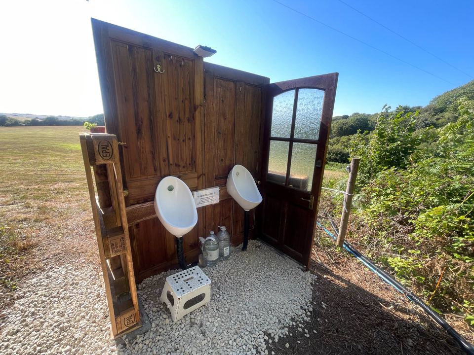 Open-air urinal by the field