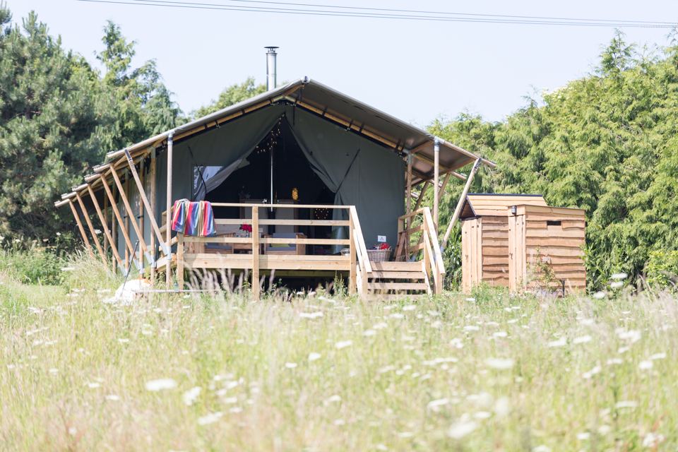 Safari tent in the wild meadow