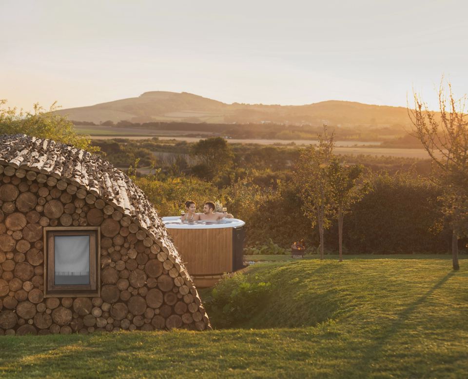 Log pod with hot tub at sunset
