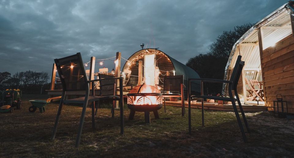Arks around a fire pit at dusk