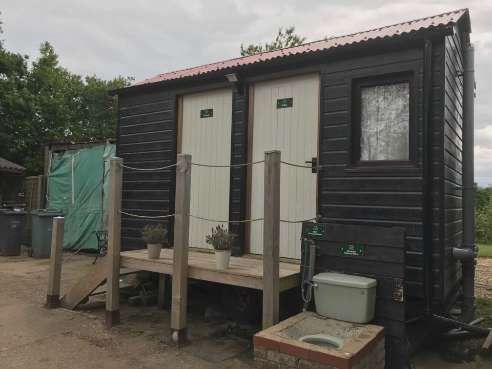 Black timber toilet and shower hut