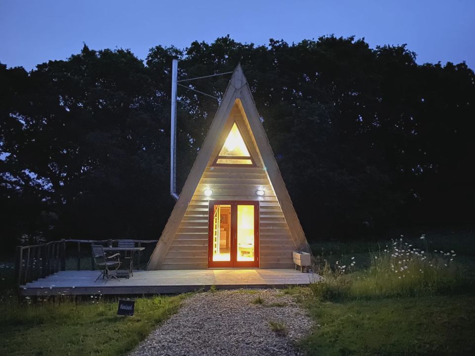 A-frame cabin lit at dusk