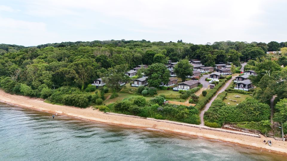 Lodges in woodland above the shore
